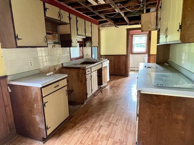 38 Clark St, Medway, MA 02053 - kitchen featuring light wood finished floors, light countertops, wainscoting, tasteful backsplash, and a baseboard heating unit