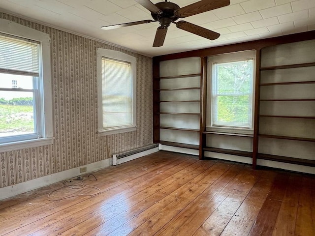 38 Clark St, Medway, MA 02053 - empty room featuring wood-type flooring, a ceiling fan, a baseboard heating unit, plenty of natural light, and wallpapered walls