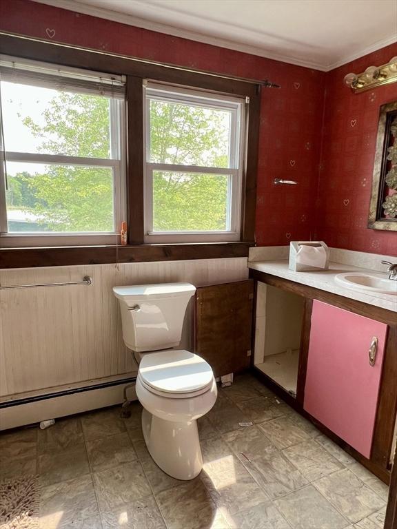 38 Clark St, Medway, MA 02053 - bathroom with baseboard heating, vanity, healthy amount of natural light, toilet, and crown molding