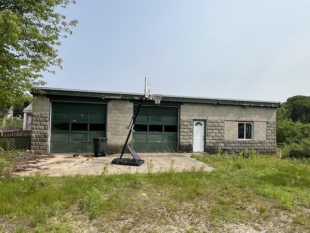 38 Clark St, Medway, MA 02053 - back of property with concrete block siding, a garage, and an outdoor structure
