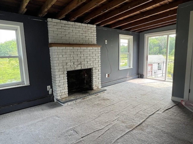 38 Clark St, Medway, MA 02053 - unfurnished living room featuring baseboard heating, carpet floors, a brick fireplace, and beam ceiling