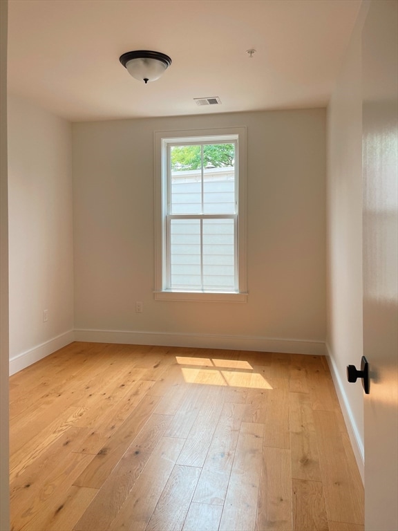 unfurnished room with light hardwood / wood-style floors