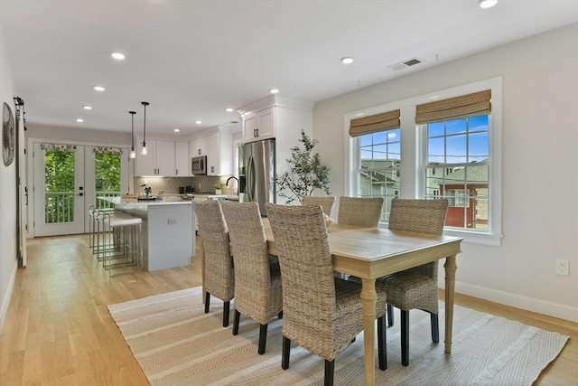 176 Medford St Unit 176, Arlington, MA 02474 - dining room with plenty of natural light, recessed lighting, light wood finished floors, and french doors