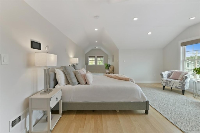 176 Medford St Unit 176, Arlington, MA 02474 - bedroom featuring lofted ceiling, multiple windows, light wood finished floors, and recessed lighting