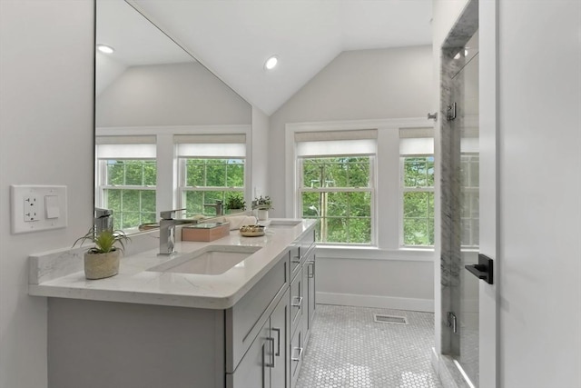 176 Medford St Unit 176, Arlington, MA 02474 - full bathroom featuring double vanity, vaulted ceiling, recessed lighting, an enclosed shower, and tile patterned floors