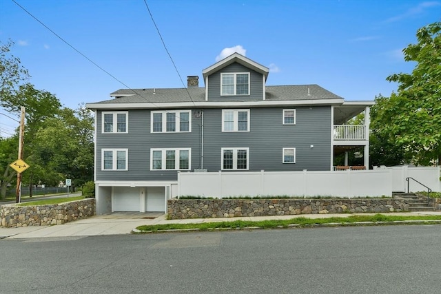 176 Medford St Unit 176, Arlington, MA 02474 - view of property exterior featuring a garage, driveway, and a chimney