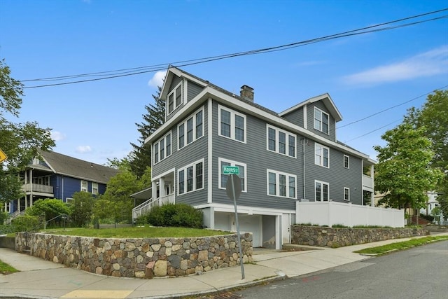 176 Medford St Unit 176, Arlington, MA 02474 - view of side of home featuring a chimney and a garage
