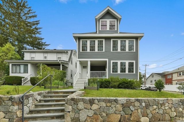 176 Medford St Unit 176, Arlington, MA 02474 - american foursquare style home featuring stairway and a front yard