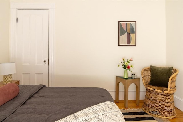 bedroom featuring baseboards and wood finished floors