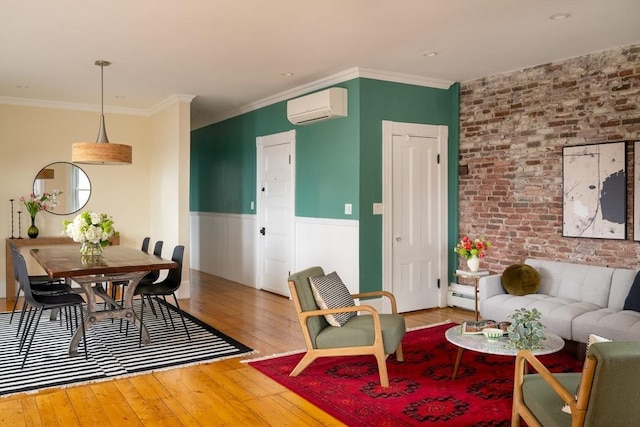 living room featuring brick wall, an AC wall unit, wainscoting, wood-type flooring, and a baseboard radiator