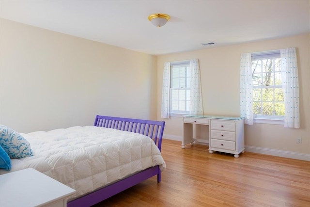 22 Forest Hill Rd, Wayland, MA 01778 - bedroom featuring light wood finished floors, multiple windows, and baseboards