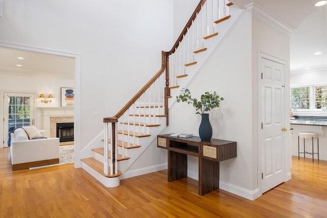 22 Forest Hill Rd, Wayland, MA 01778 - staircase with wood finished floors, recessed lighting, ornamental molding, a premium fireplace, and baseboards