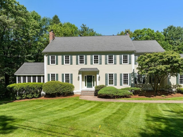 22 Forest Hill Rd, Wayland, MA 01778 - colonial home featuring a chimney and a front lawn