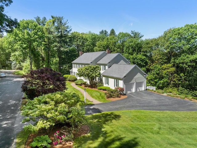 22 Forest Hill Rd, Wayland, MA 01778 - view of front facade featuring a front yard, asphalt driveway, a chimney, and an attached garage