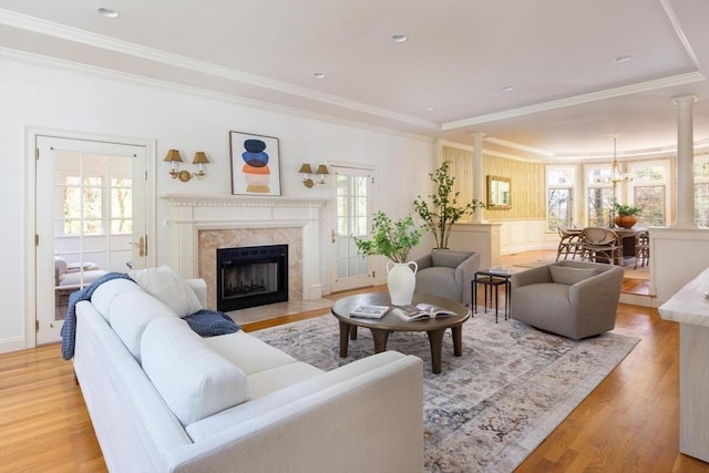 22 Forest Hill Rd, Wayland, MA 01778 - living room featuring light wood-style floors, ornamental molding, a premium fireplace, and a chandelier