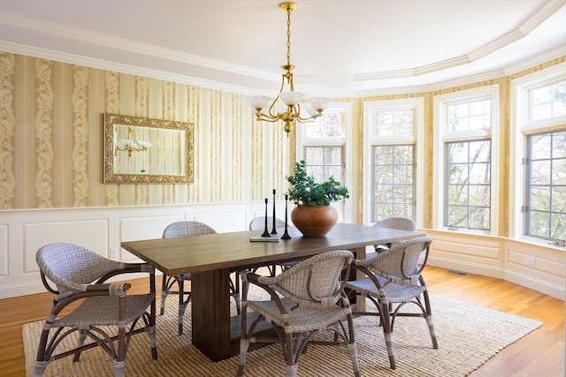 22 Forest Hill Rd, Wayland, MA 01778 - dining room with plenty of natural light, crown molding, a chandelier, light wood-style floors, and a decorative wall