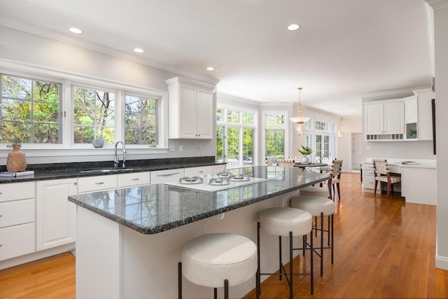 22 Forest Hill Rd, Wayland, MA 01778 - kitchen featuring white gas cooktop, a sink, white cabinetry, crown molding, and recessed lighting