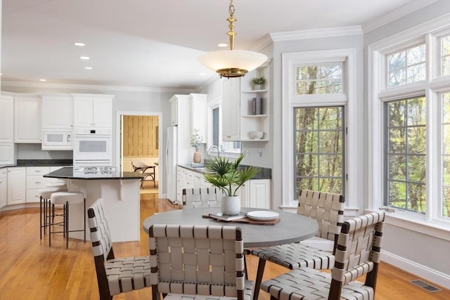 22 Forest Hill Rd, Wayland, MA 01778 - dining space with light wood-style flooring, crown molding, baseboards, and recessed lighting