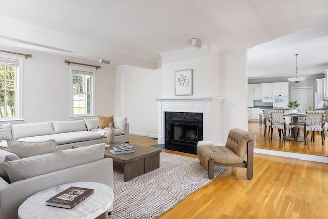 22 Forest Hill Rd, Wayland, MA 01778 - living room with light wood finished floors, a fireplace, and crown molding