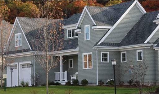 rear view of property with a yard and a garage