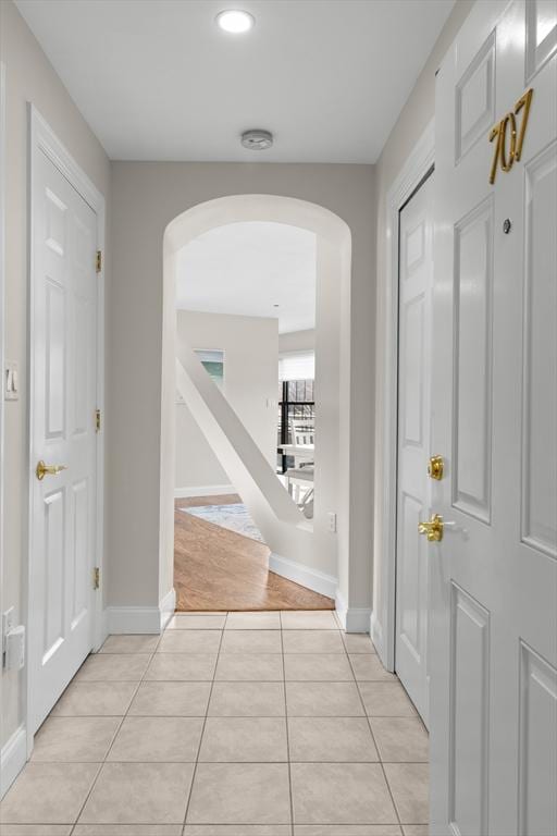 corridor featuring light tile patterned floors