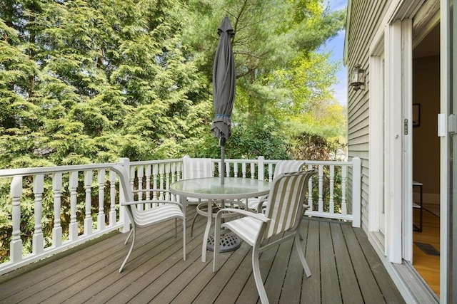 wooden terrace featuring outdoor dining space