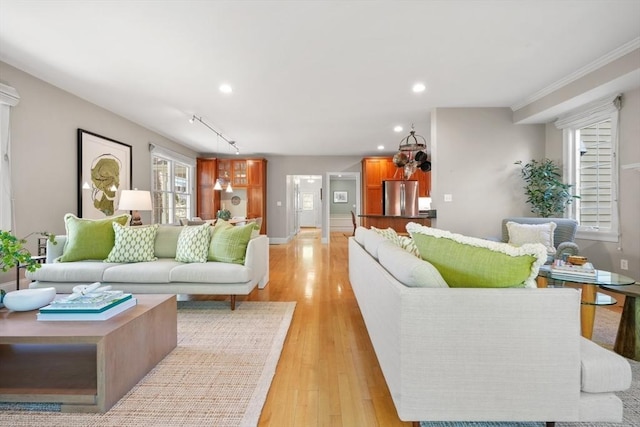 living area featuring recessed lighting, baseboards, and light wood-style floors