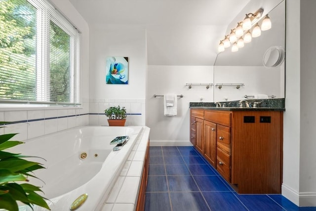 bathroom featuring baseboards, a tub with jets, tile patterned flooring, and double vanity
