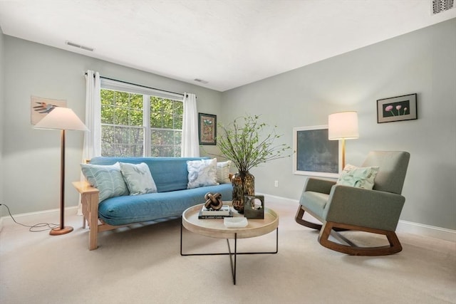 living room with carpet, baseboards, and visible vents