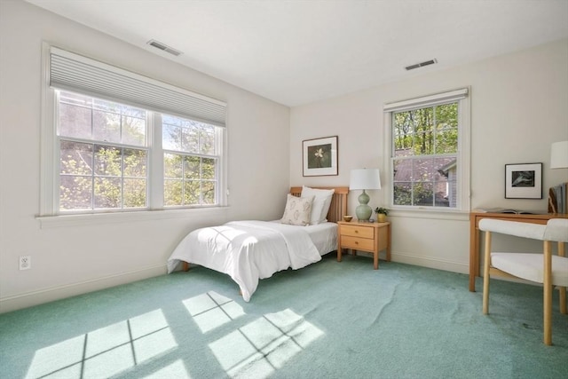 bedroom featuring baseboards, carpet flooring, and visible vents