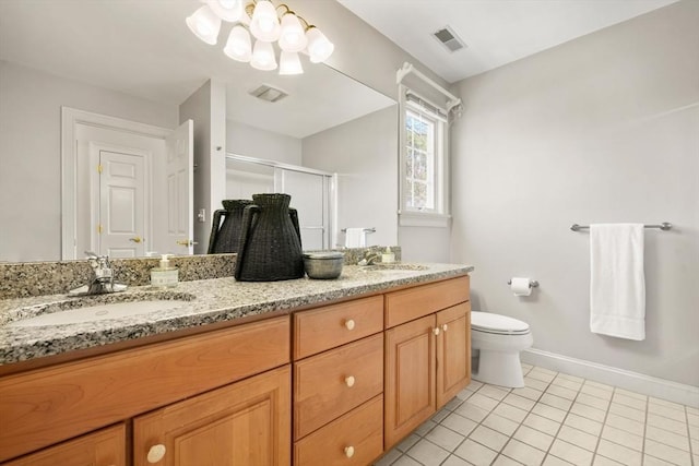 bathroom featuring a sink, toilet, a stall shower, and visible vents