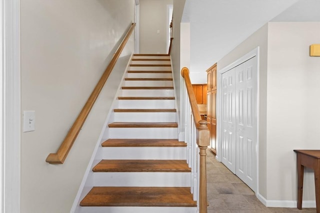 staircase featuring baseboards