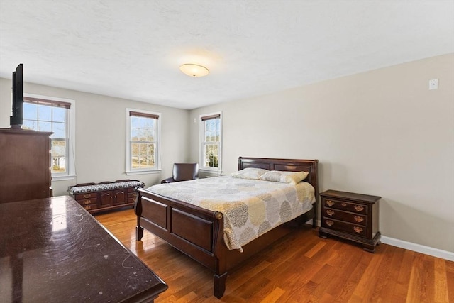 bedroom with wood finished floors and baseboards