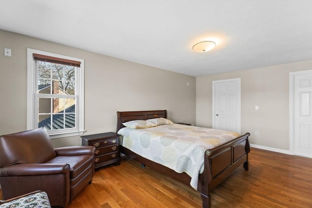 bedroom featuring baseboards and wood finished floors