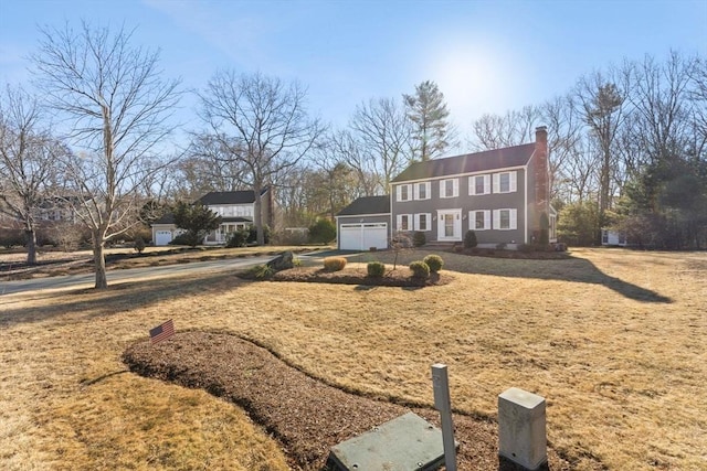 view of front of home featuring a chimney and an attached garage