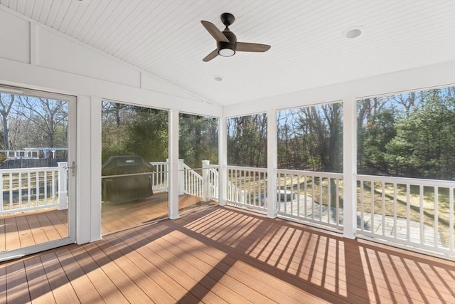 unfurnished sunroom featuring lofted ceiling and ceiling fan