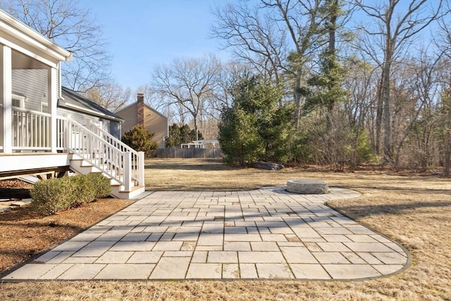 view of patio / terrace featuring a fire pit, a deck, stairs, and fence