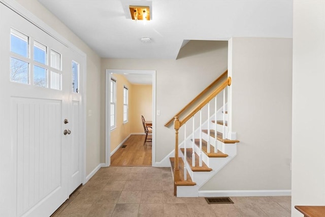 entryway featuring stairs, visible vents, and baseboards