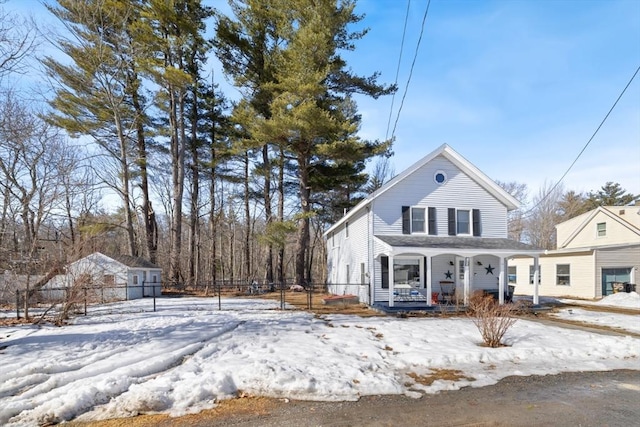 view of front of property featuring fence and a porch