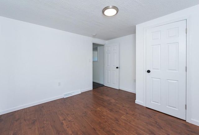 258-260 Pleasant St, Lowell, MA 01852 - empty room with wood finished floors, baseboards, and a textured ceiling