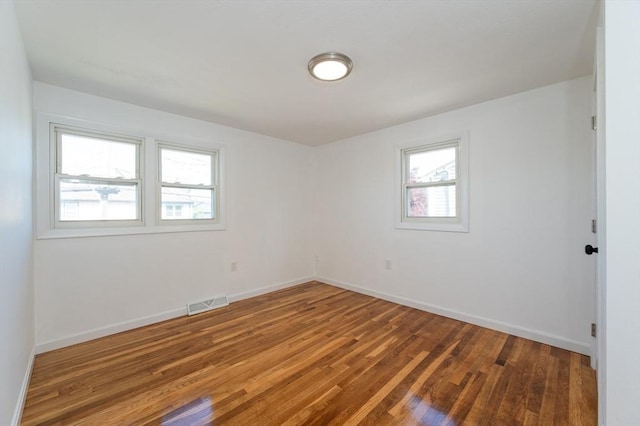 258-260 Pleasant St, Lowell, MA 01852 - empty room with wood finished floors and baseboards