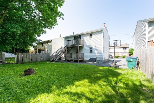 258-260 Pleasant St, Lowell, MA 01852 - rear view of house with a fire pit, stairway, and a deck