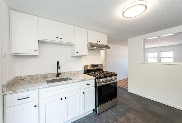 258-260 Pleasant St, Lowell, MA 01852 - kitchen featuring stainless steel range with gas cooktop, under cabinet range hood, a sink, dark wood-style floors, and white cabinetry