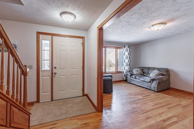 entrance foyer featuring a textured ceiling and light hardwood / wood-style floors