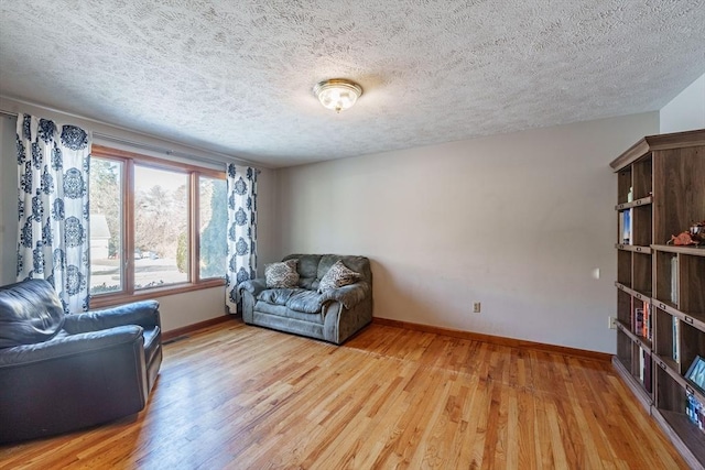 sitting room with light hardwood / wood-style flooring and a textured ceiling