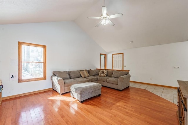 living room featuring high vaulted ceiling, ceiling fan, and light wood-type flooring