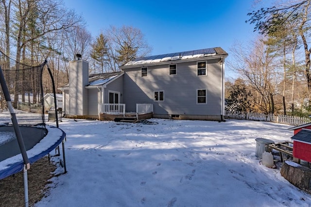 snow covered property with a trampoline