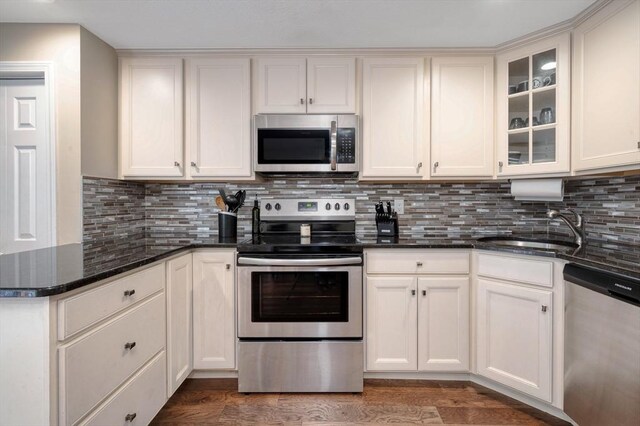 1608 Plymouth St Unit 1608, East Bridgewater, MA 02333 - kitchen featuring appliances with stainless steel finishes, a sink, dark stone counters, and backsplash