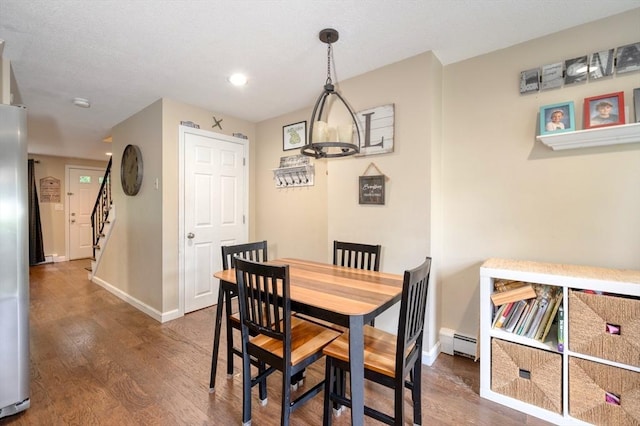 1608 Plymouth St Unit 1608, East Bridgewater, MA 02333 - dining room featuring a baseboard radiator, wood finished floors, baseboards, stairway, and recessed lighting