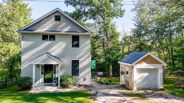 6 Edgehill Rd, Billerica, MA 01862 - view of front facade with an outdoor structure, dirt driveway, a garage, and view of wooded area